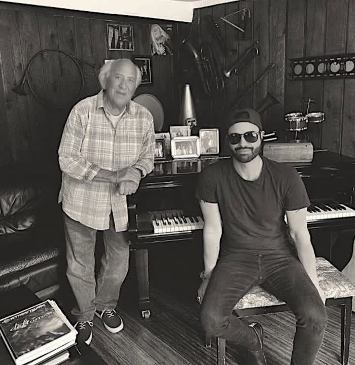 ADOM singer songwriter at a piano, from the Radar Online feature.